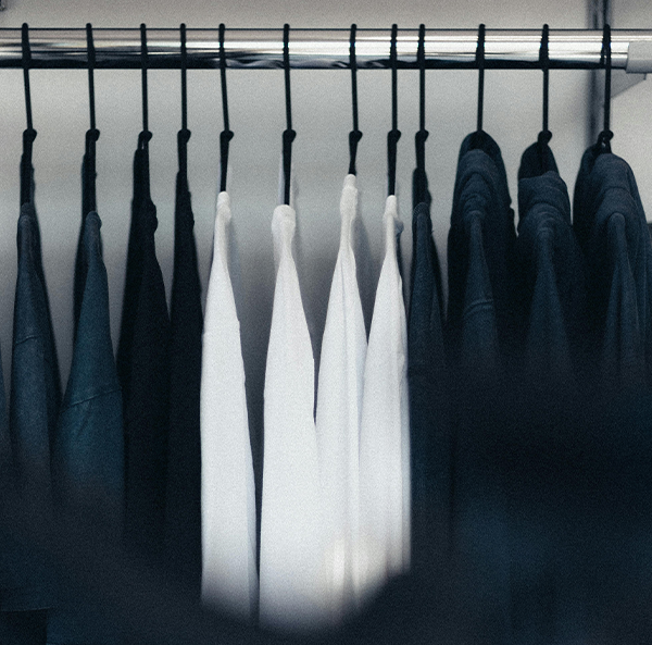 fashion showroom with black and white shirts hanging on rail