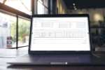 showing a close-up of a computer screen with the TRIMIT manufacturing dashboard